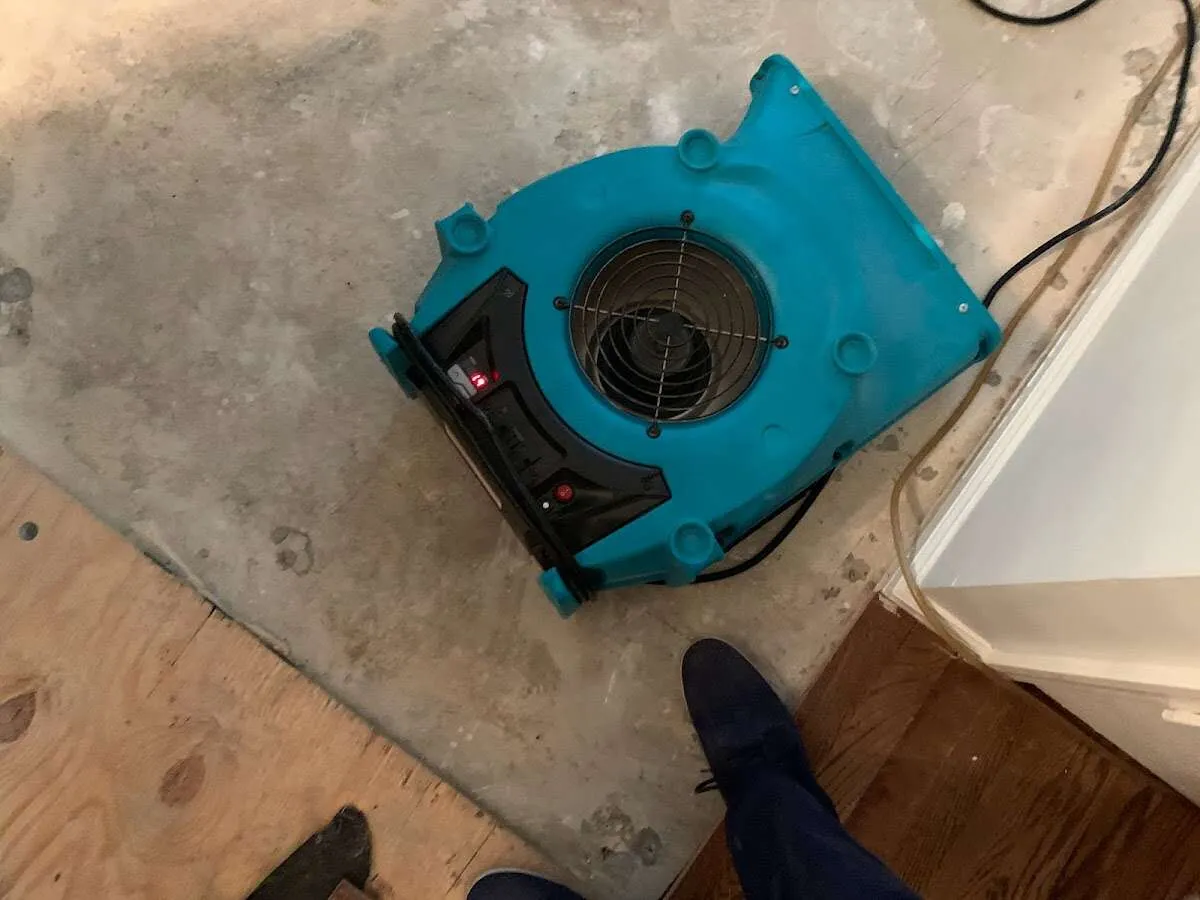 Air mover drying subfloor during Commercial Water Damage Restoration in Gorham